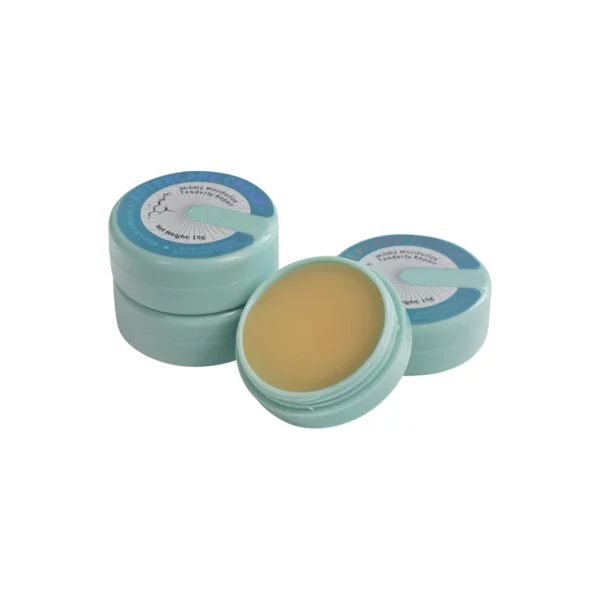 1_2 Three open mint-green lip balm containers with labels.