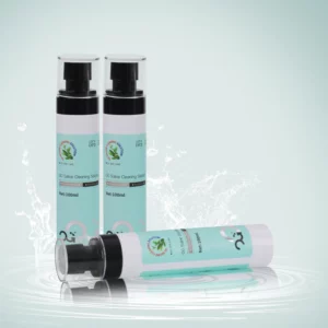 Three skincare bottles with green labels on a watery surface.