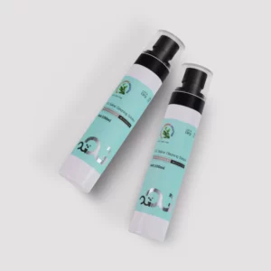 Two bottles of skincare cream with green labels on a gray background.