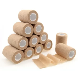 Stack of beige medical bandage rolls, some unrolled.